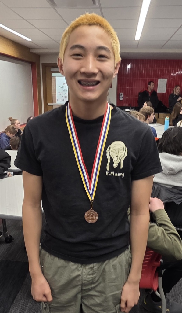 a student with a medal around his neck