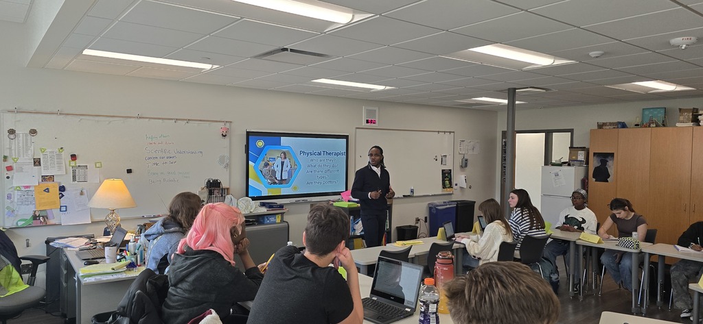 a presenter speaking with students