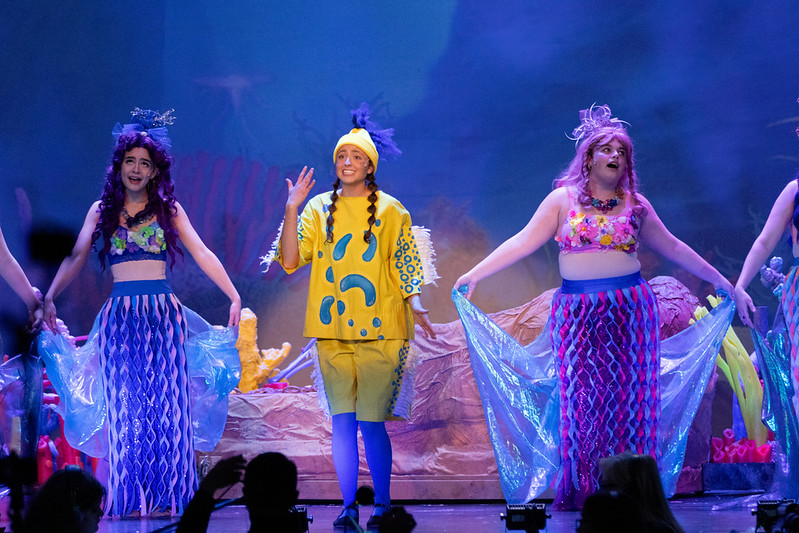 a picture of a girls in yellow talking
