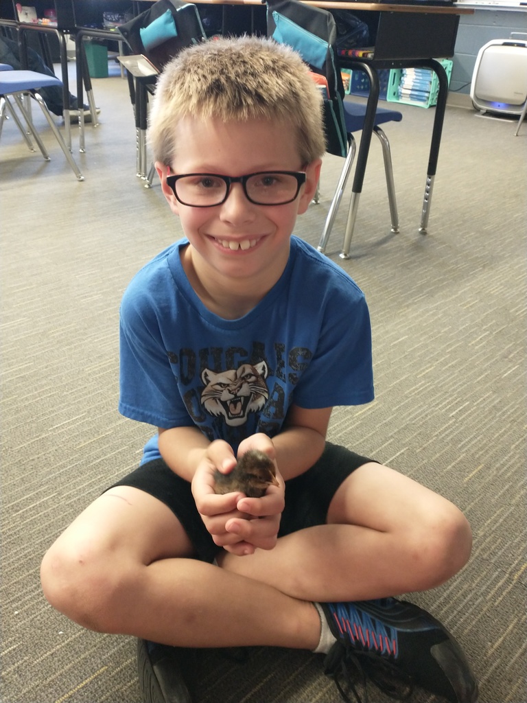 student holding chick