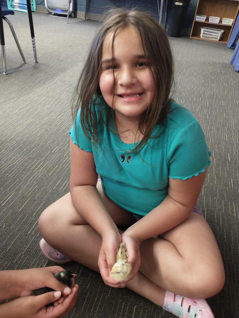 student holding chick