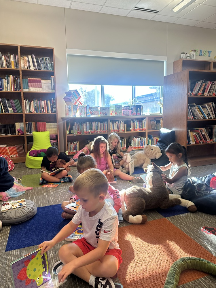 Reading to their stuffy friends  