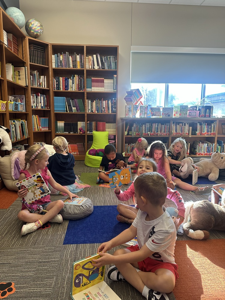 Reading to their stuffy friends  