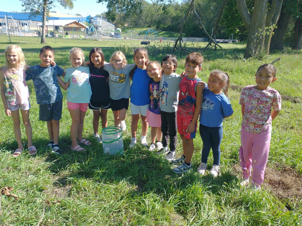 students standing by a butterfly net