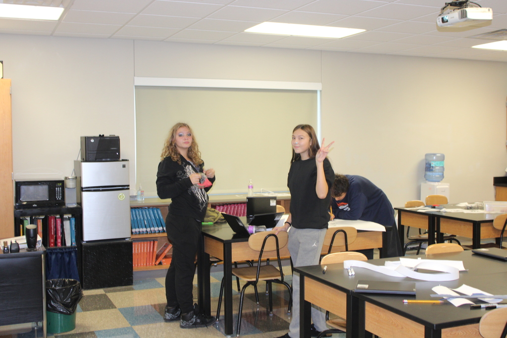two 7th grade girls working in a classroom 