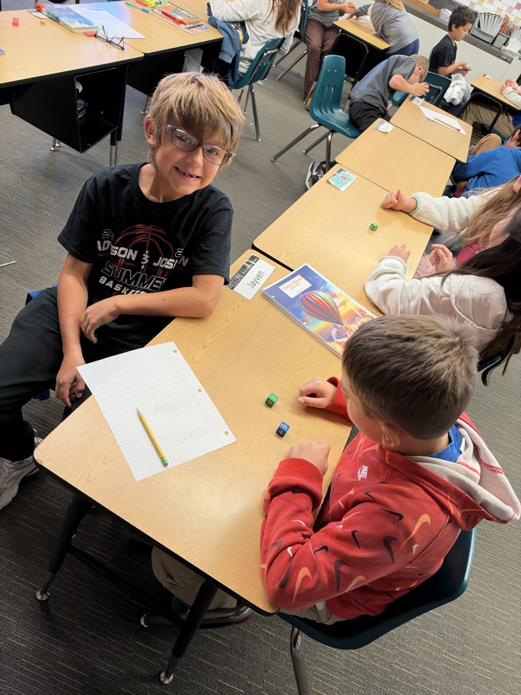 Third-grade students engage in an interactive game called Roll and Multiply to practice multiplication facts in a fun and engaging way while building fact fluency.