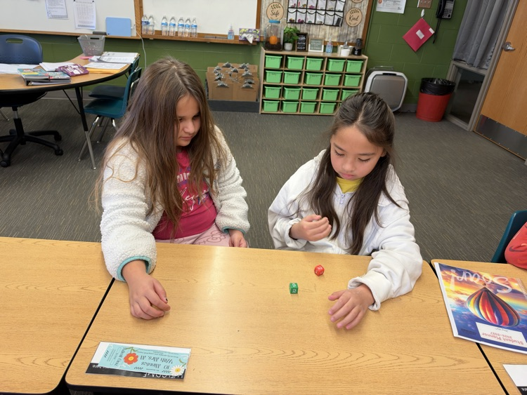 Third-grade students engage in an interactive game called Roll and Multiply to practice multiplication facts in a fun and engaging way while building fact fluency.
