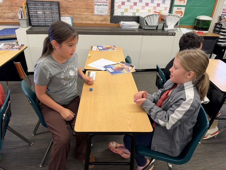Third-grade students engage in an interactive game called Roll and Multiply to practice multiplication facts in a fun and engaging way while building fact fluency.
