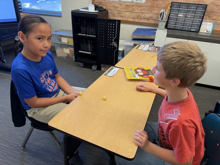 Third-grade students engage in an interactive game called Roll and Multiply to practice multiplication facts in a fun and engaging way while building fact fluency.