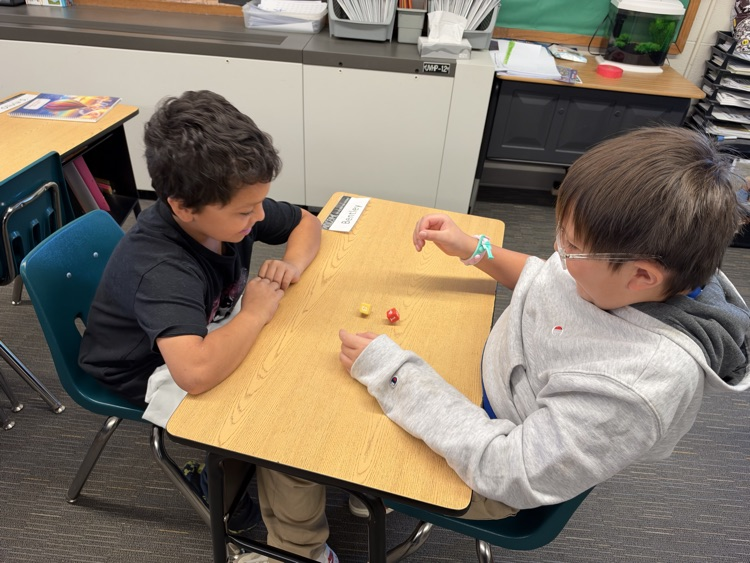 Third-grade students engage in an interactive game called Roll and Multiply to practice multiplication facts in a fun and engaging way while building fact fluency.