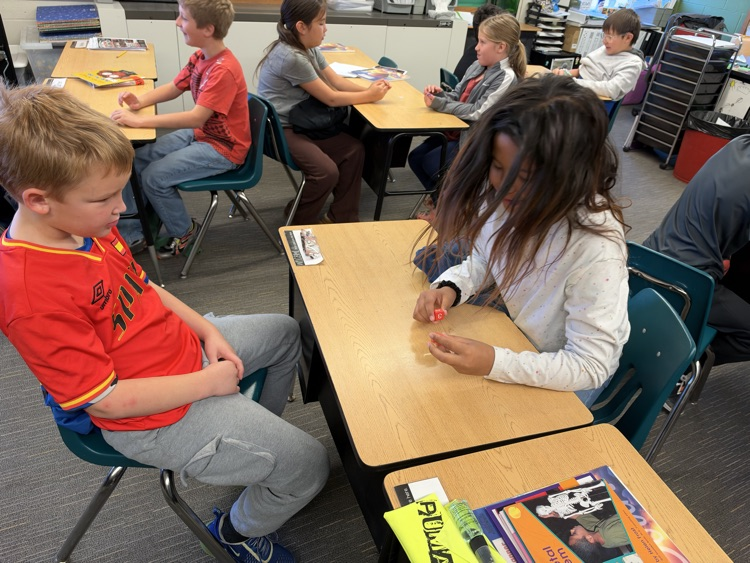 Third-grade students engage in an interactive game called Roll and Multiply to practice multiplication facts in a fun and engaging way while building fact fluency.