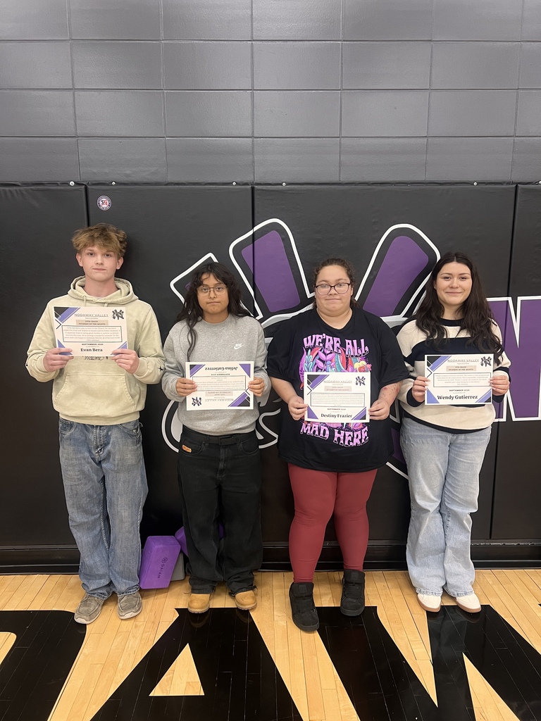 4 students holding their students of the month awards
