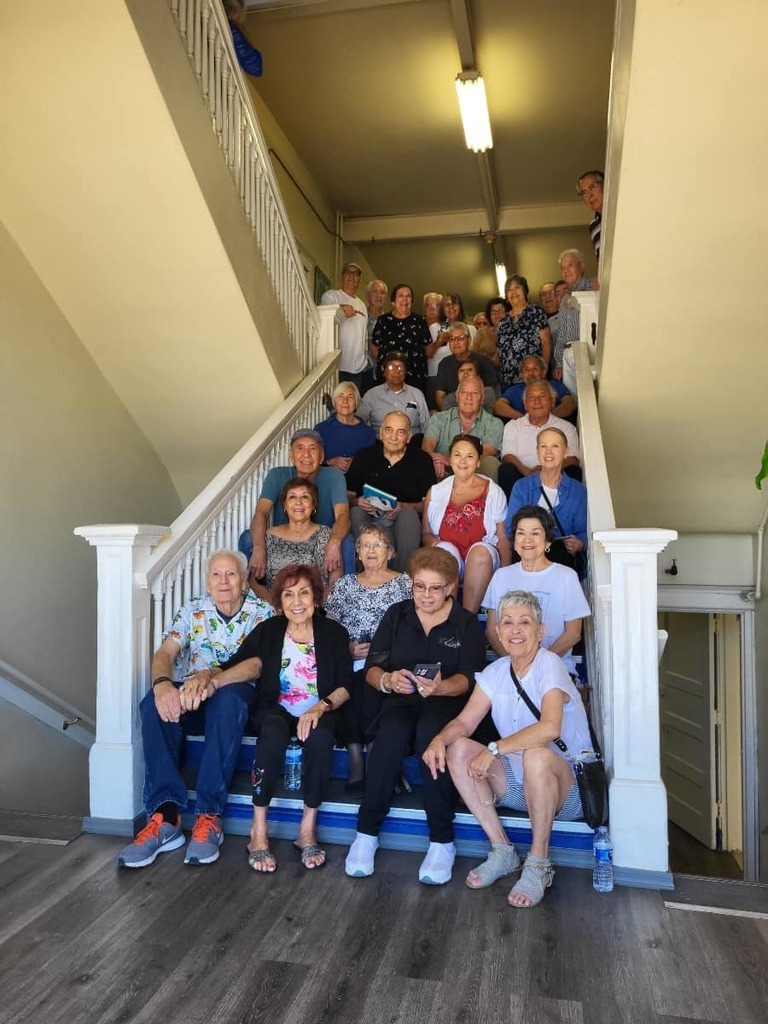 Photo of alumni sitting on stairs
