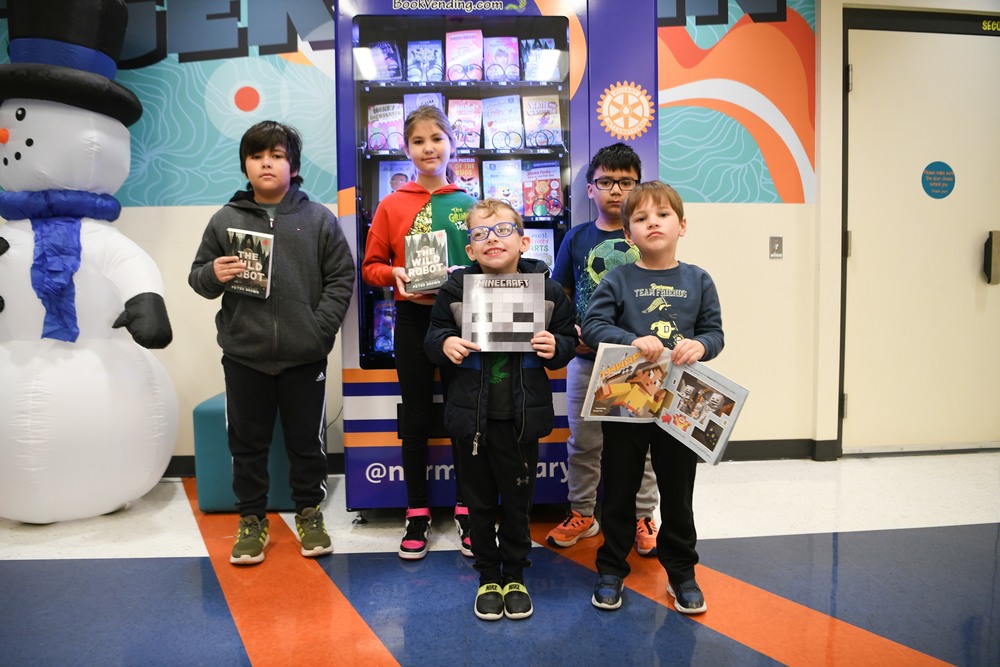 Jackson Elementary students getting a book from the book vending machine.