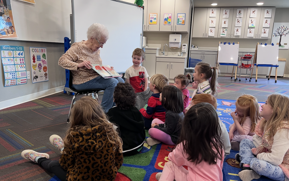 Photo of grandfriend reading to students