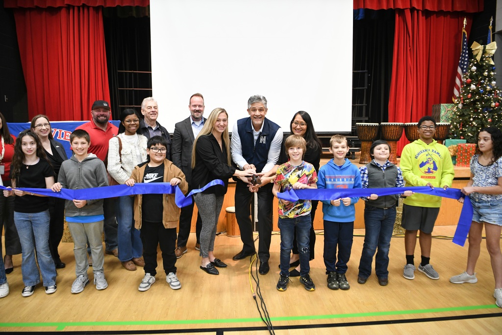 Dr. Nick with students cutting the ribbon.