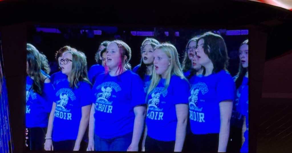 Photos of Whittier Choir singing at the OU Women's Basketball Game.