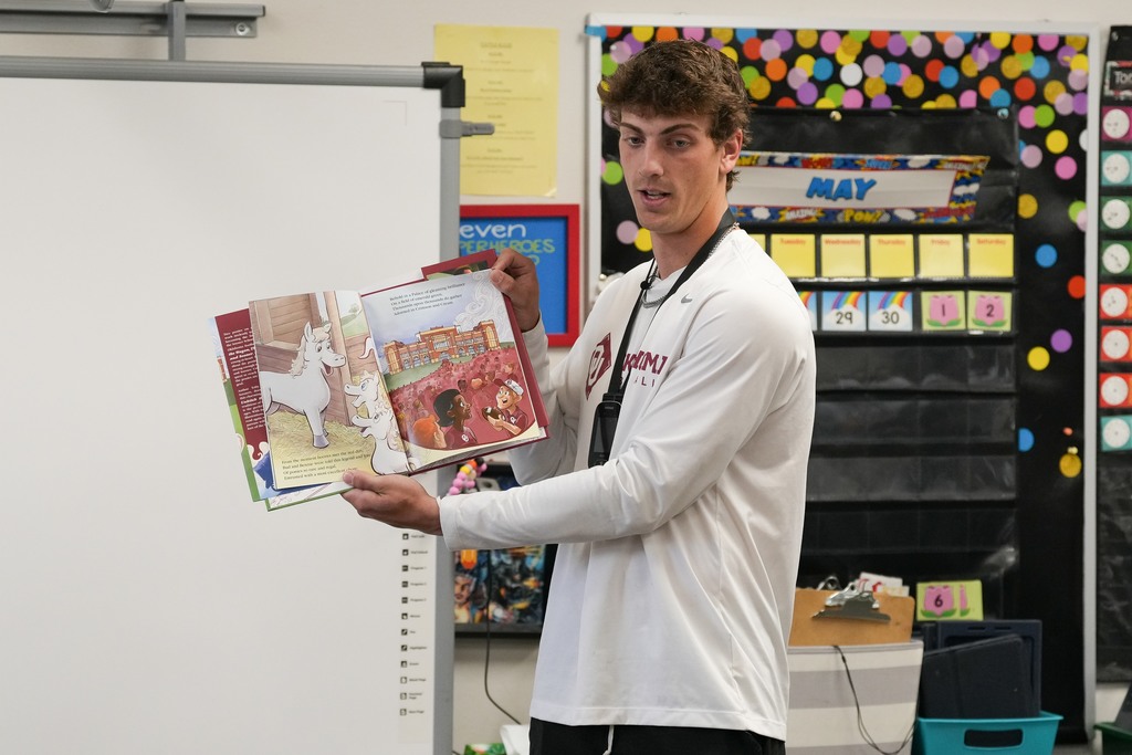 Various photos of Brendan Brock reading to kids.