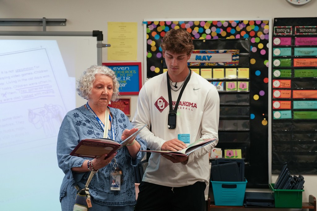 Various photos of Brendan Brock reading to kids.