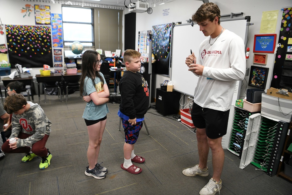 Various photos of Brendan Brock reading to kids.