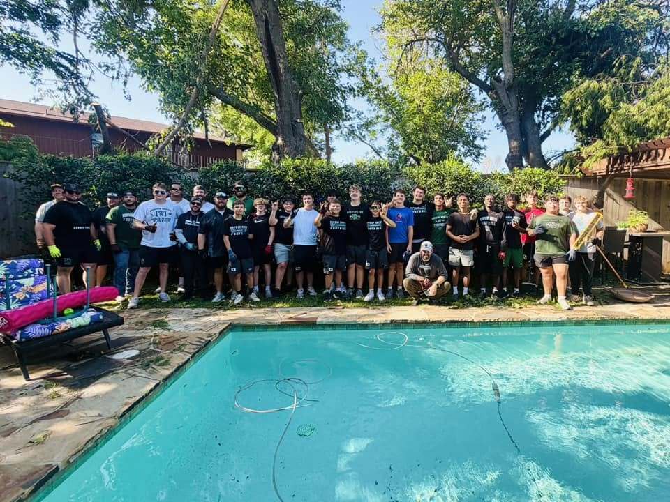 Various photos of Norman High football team helping clean up after storms.