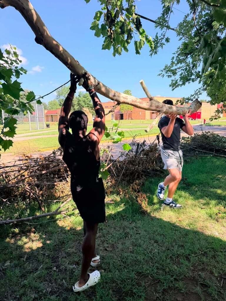 Various photos of Norman High football team helping clean up after storms.
