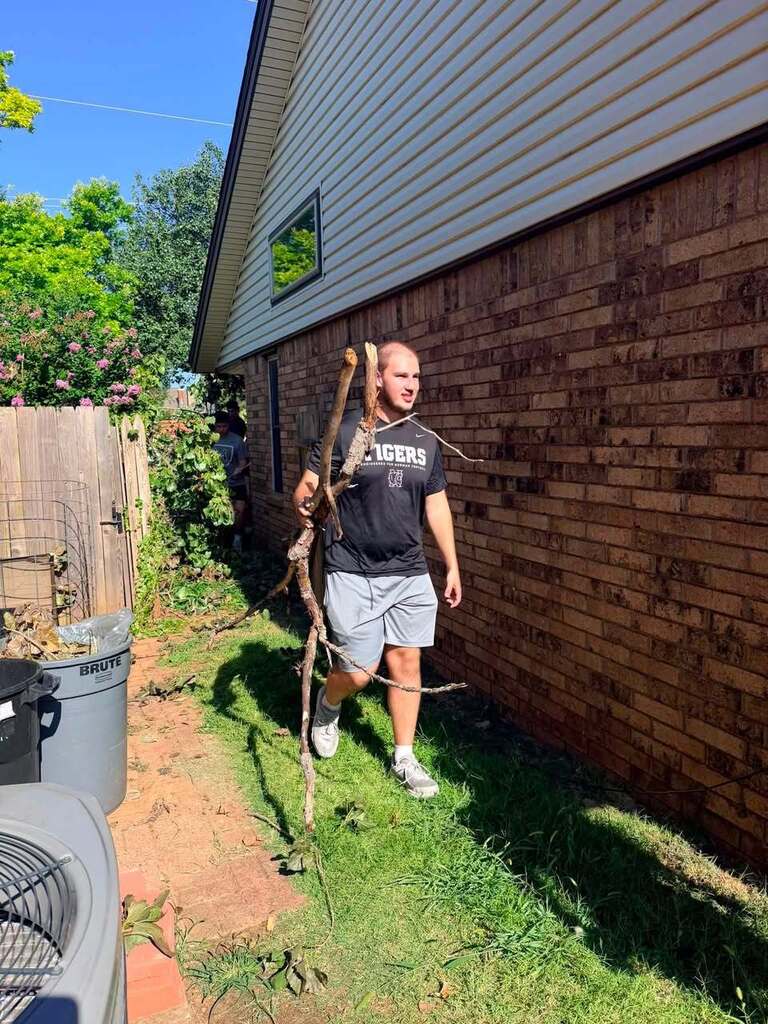 Various photos of Norman High football team helping clean up after storms.