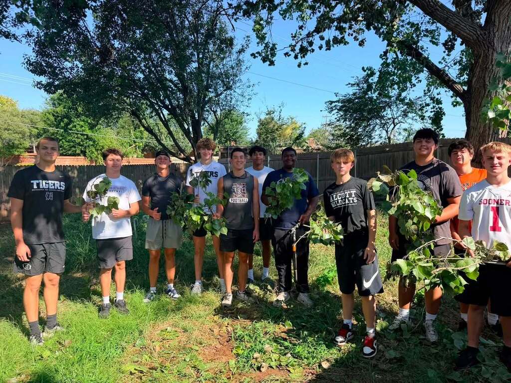 Various photos of Norman High football team helping clean up after storms.