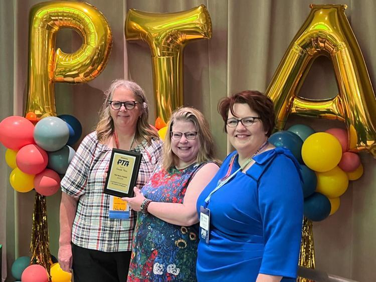 Board member Annette Price with a PTA award via the Norman Transcript