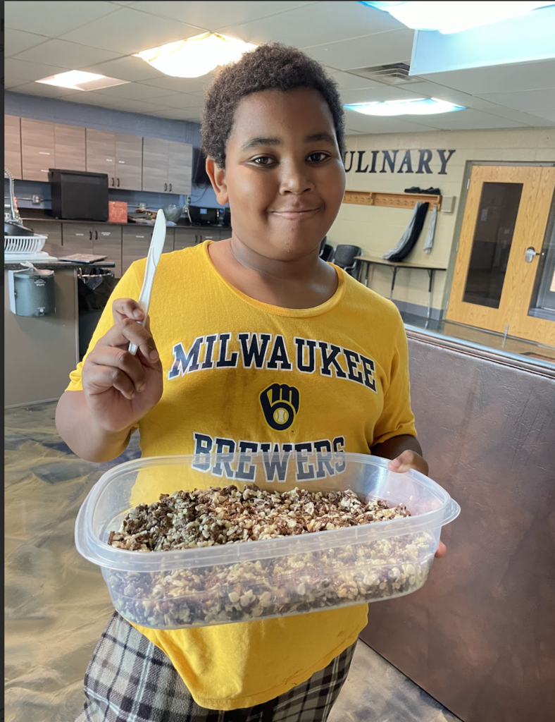learner showing off his homemade rice krispie treats