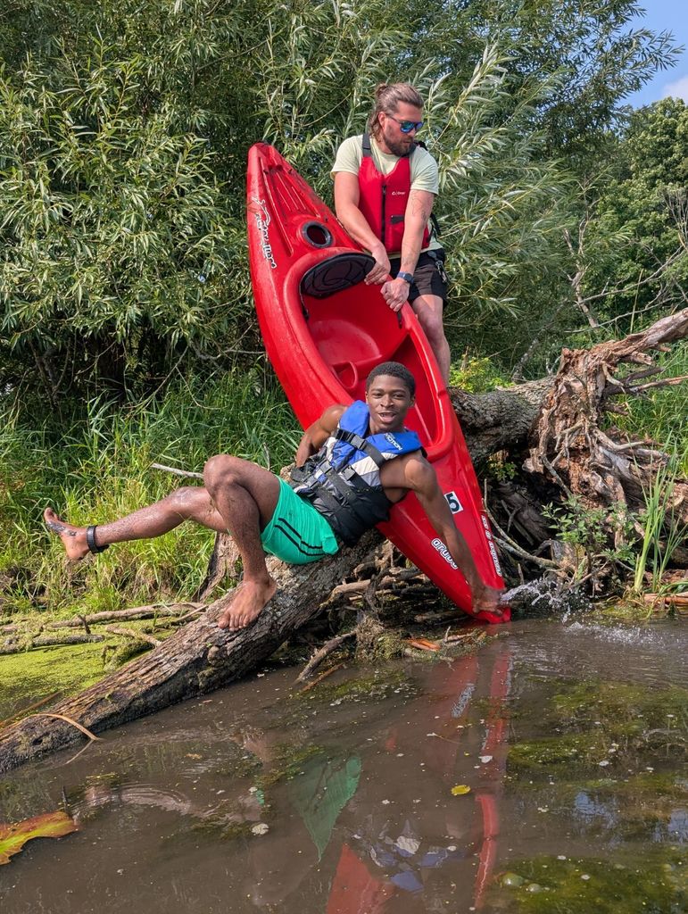 learner and staff taking a break from kayaking