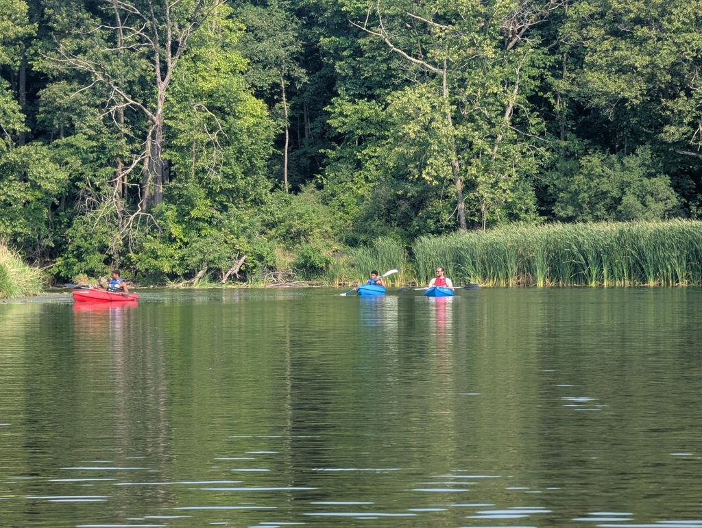 staff with 2 learners kayaking in the river
