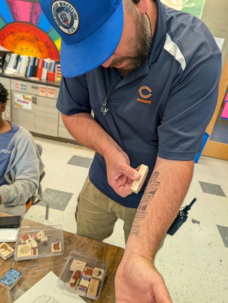 Male staff putting on ink tattoo