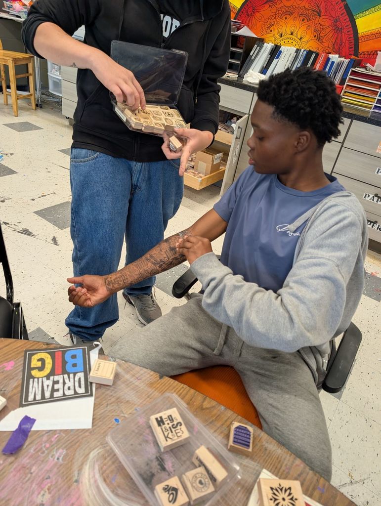 Learner getting ink stamped tattoos