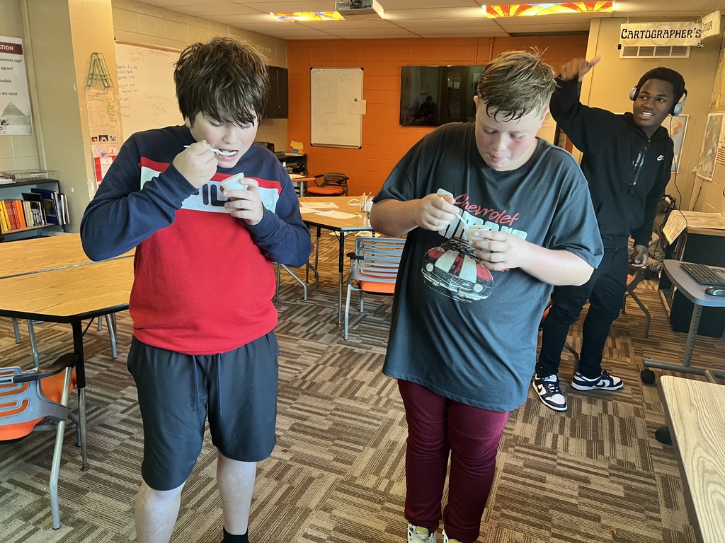 learners eating stew in classroom