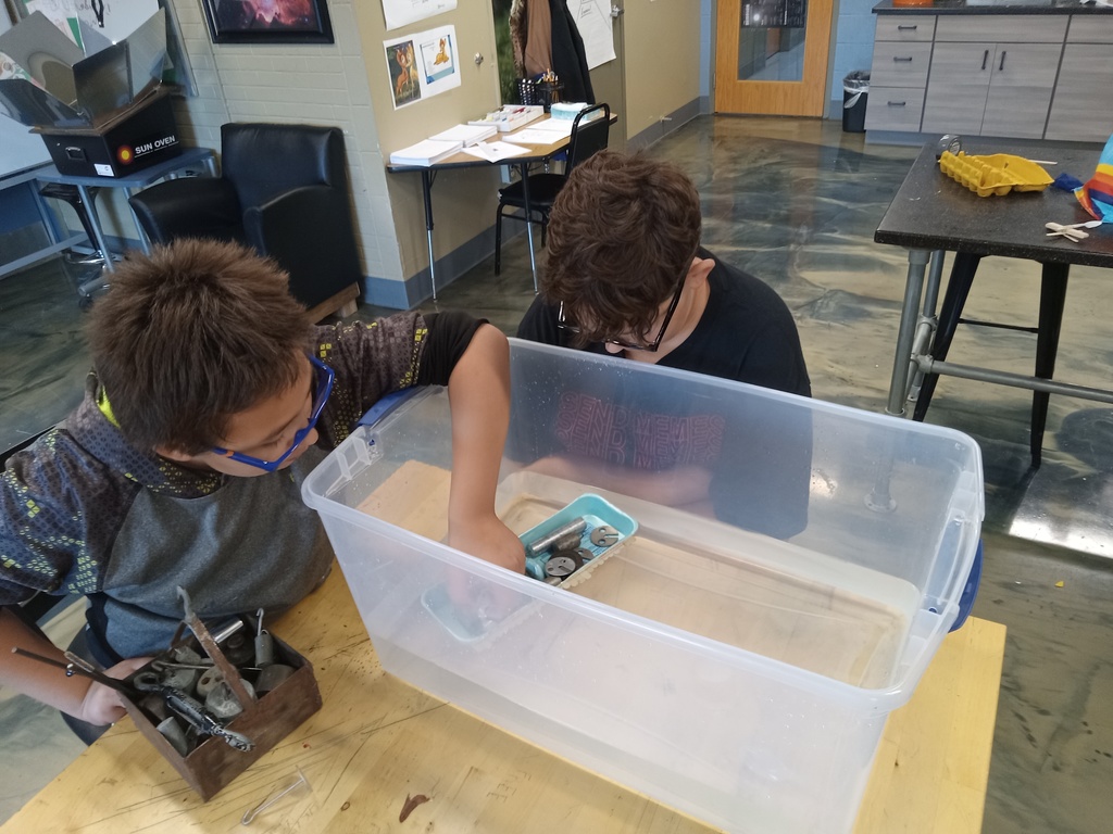 learners building a boat to float in a tub of water