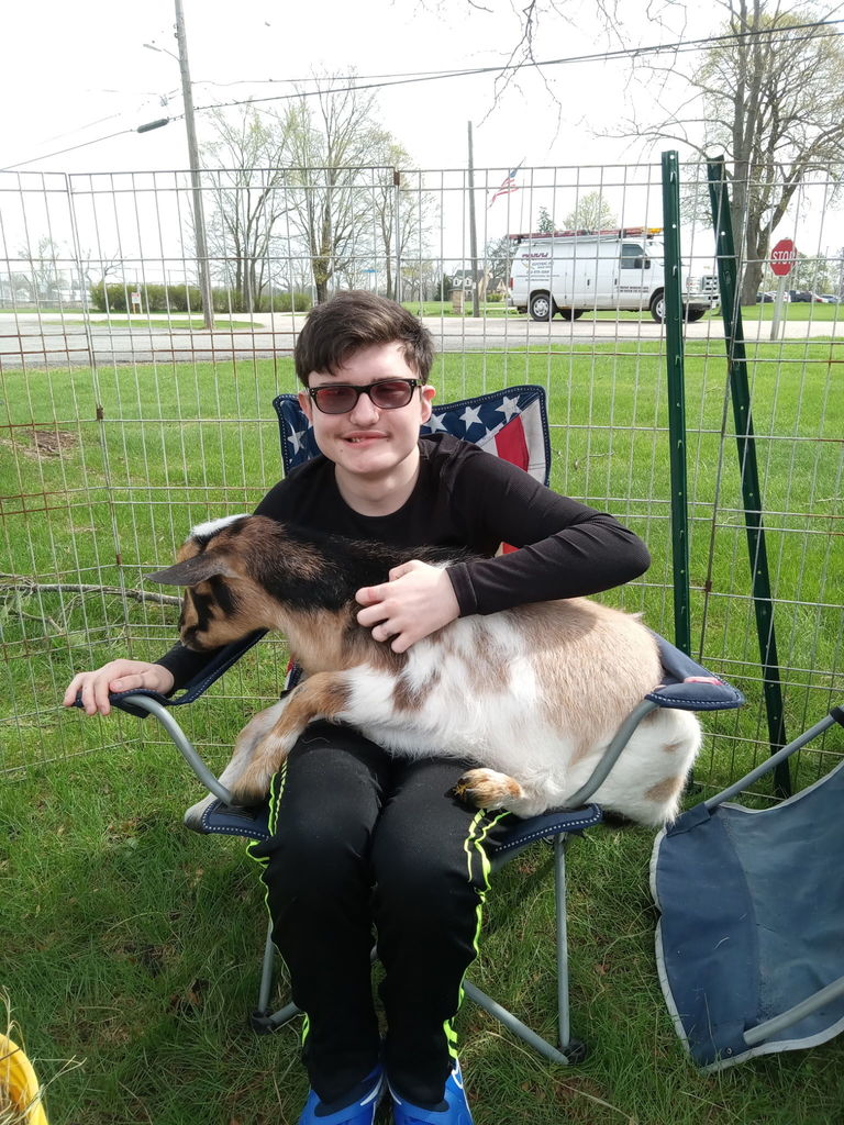 learner with goat on his lap