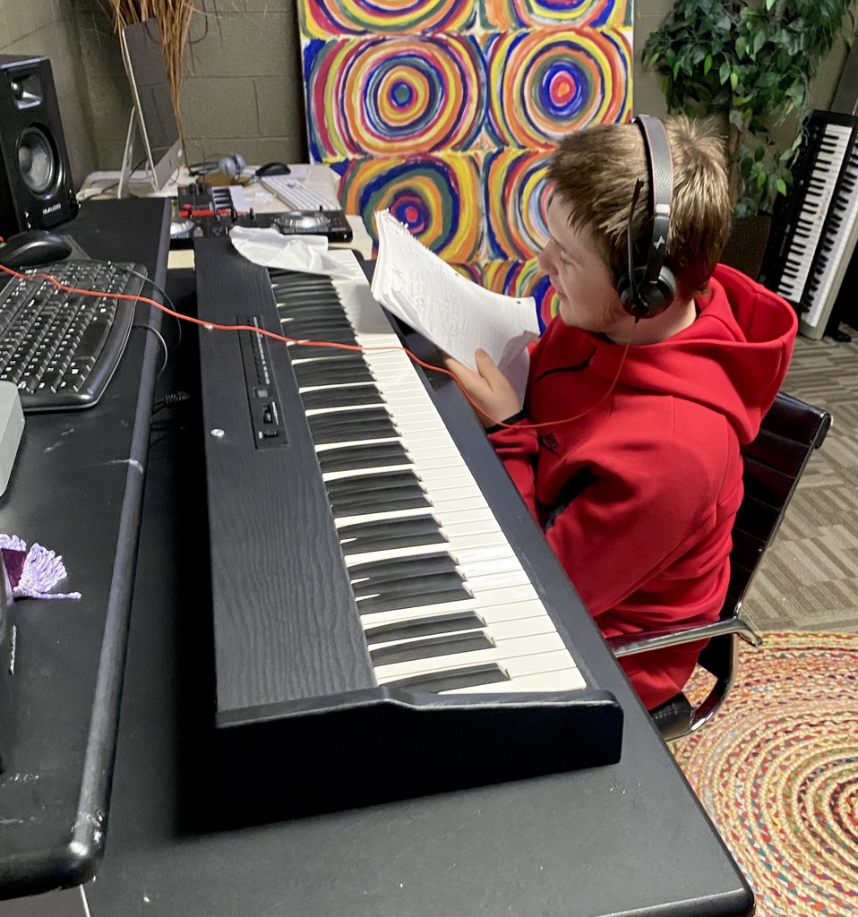 male learner playing a keyboard. 