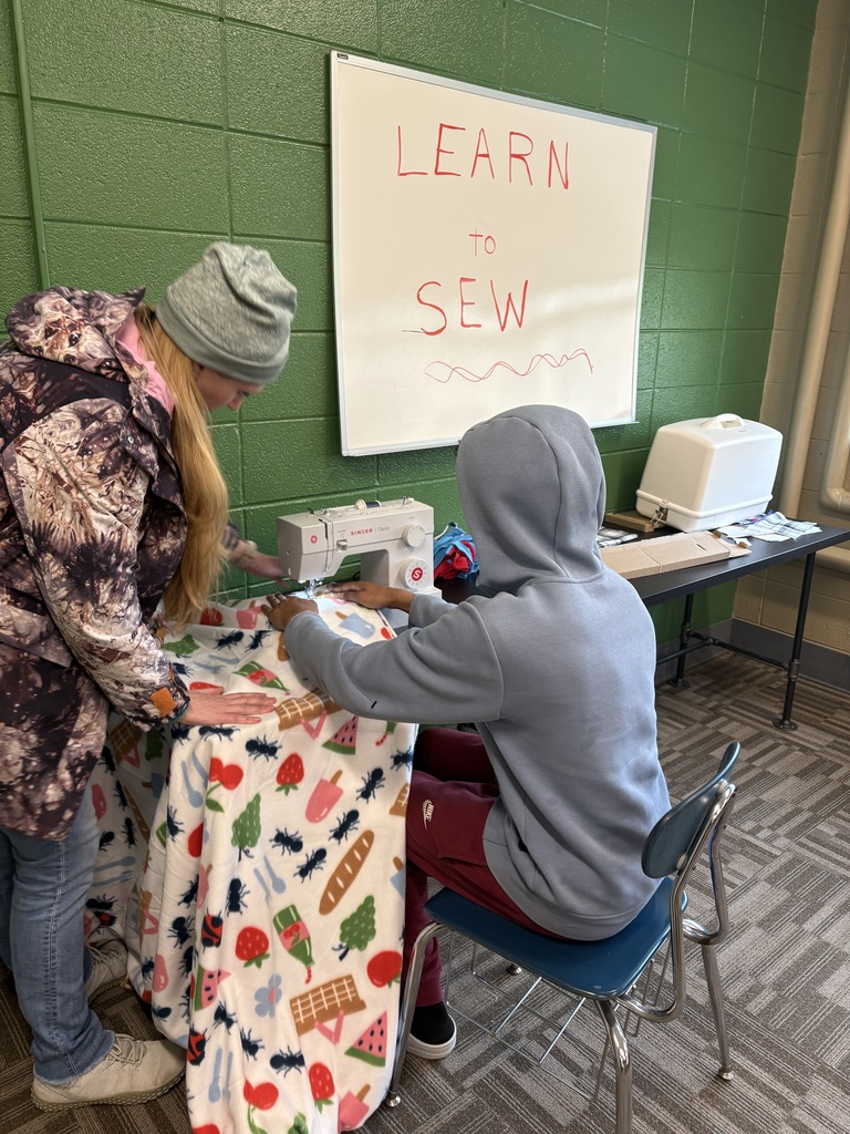 male learner learning to sew