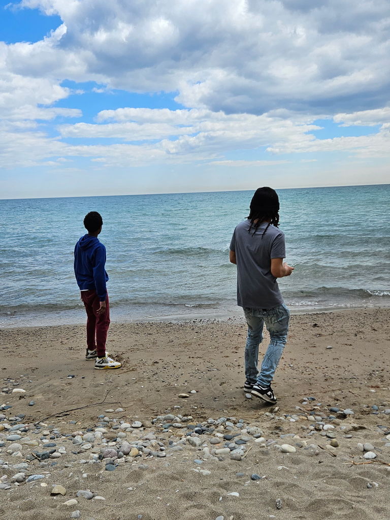 learners skipping rock on the lake