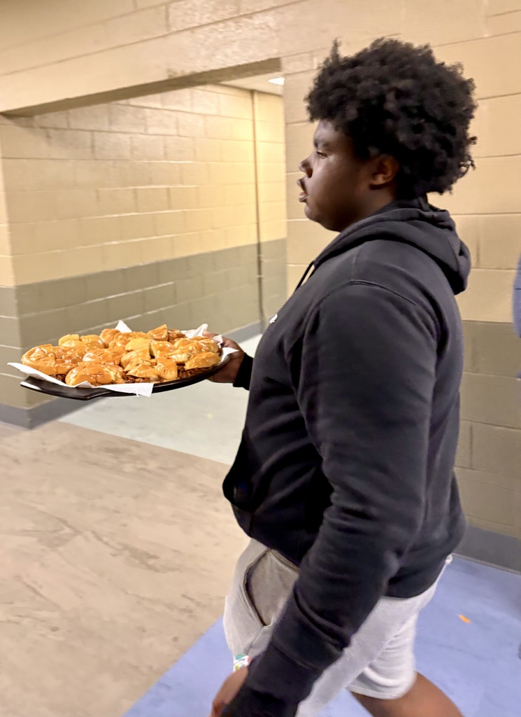 Learner carrying a tray of sandwiches