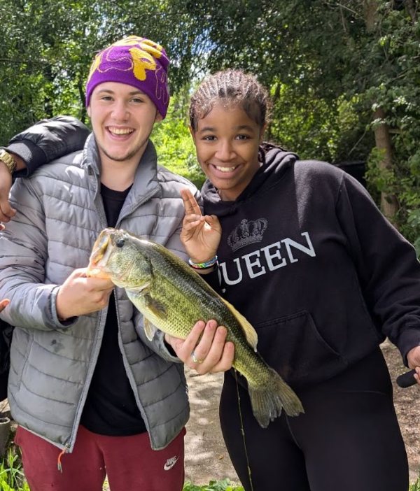 Youth holding large fish they caught