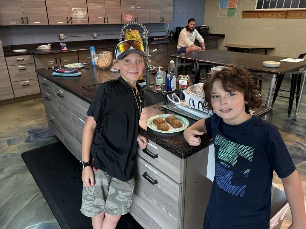 learners showing off muffins they made