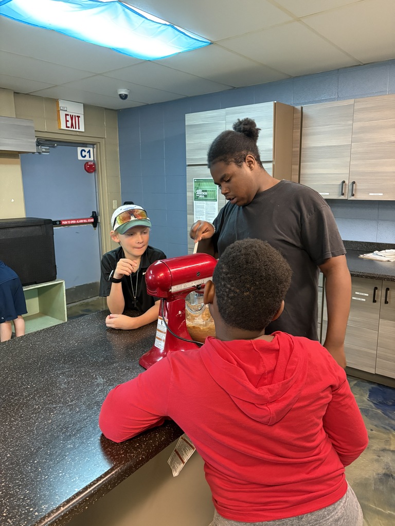 learners using a stand mixer to make muffins