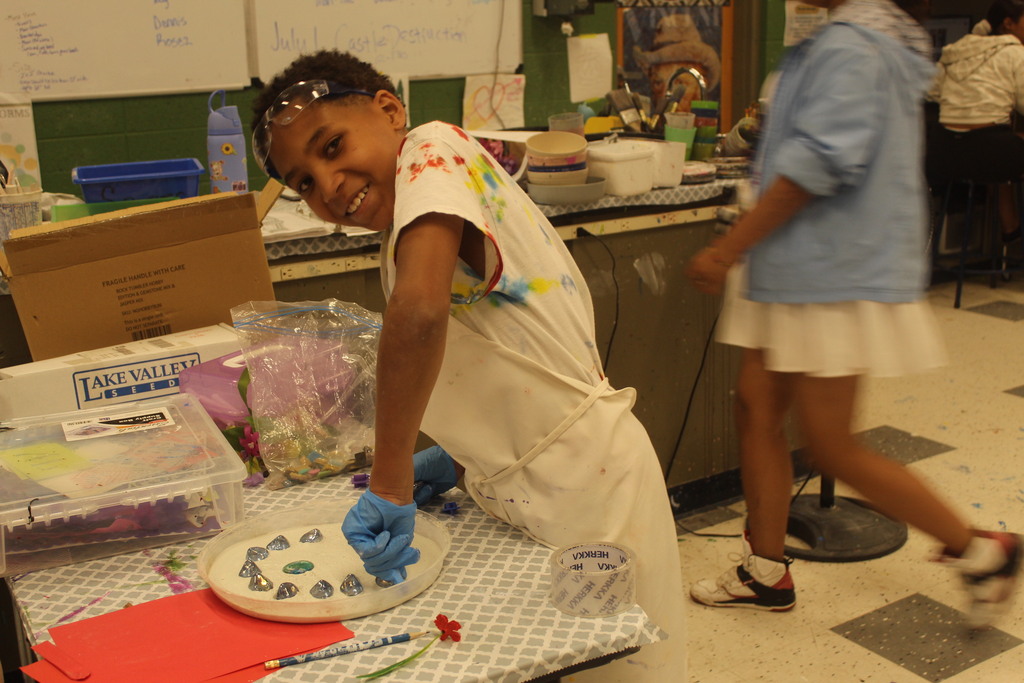 younger learners making a garden stone