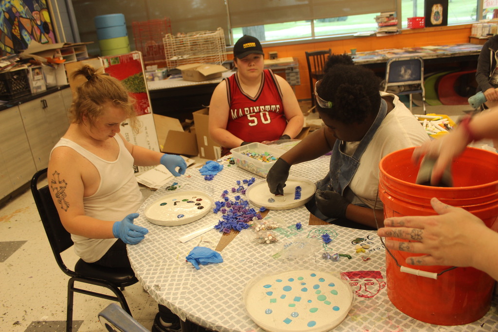 3 learners workingon making garden stones