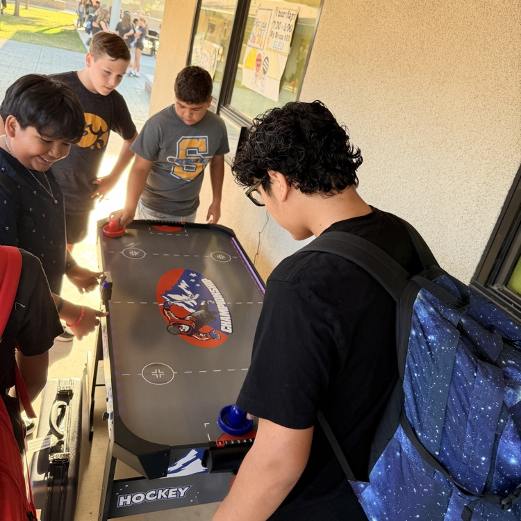 Students playing air hockey