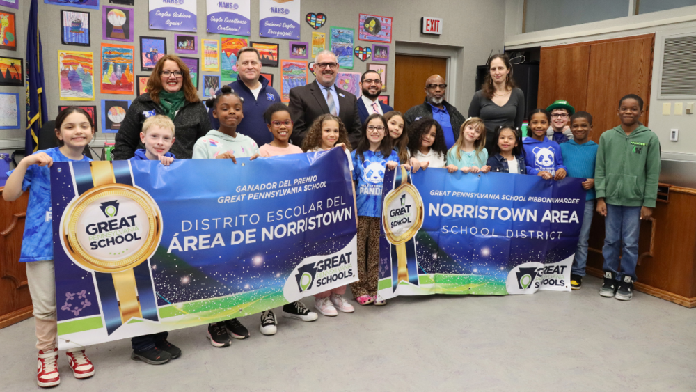 Students holding up Great PA School Banners with Board members standing behind them