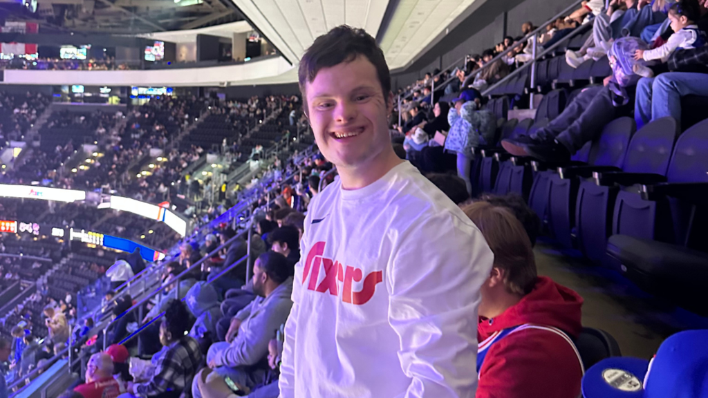 Student smiling at camera while in the stands