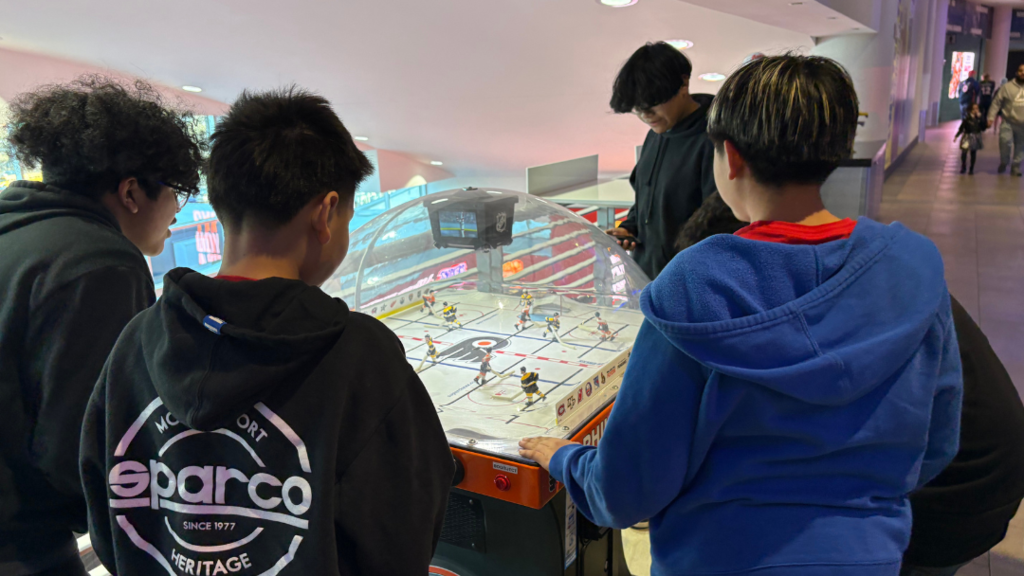 Students playing table hockey inside the arena